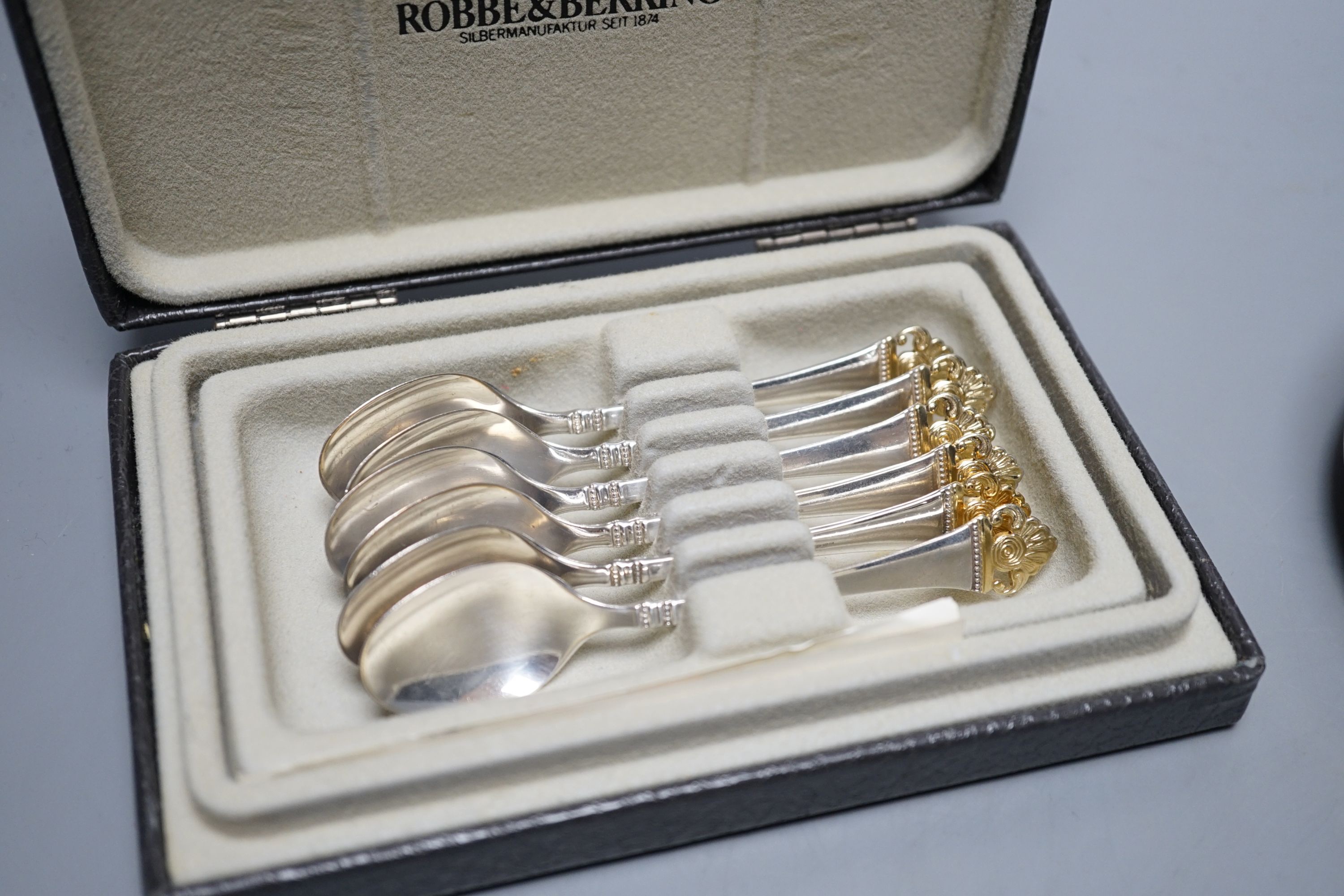A cased set of six German 800 standard teaspoons by Robbe & Berking, a set of six silver mounted glass coaster and a modern silver mounted wine coaster.